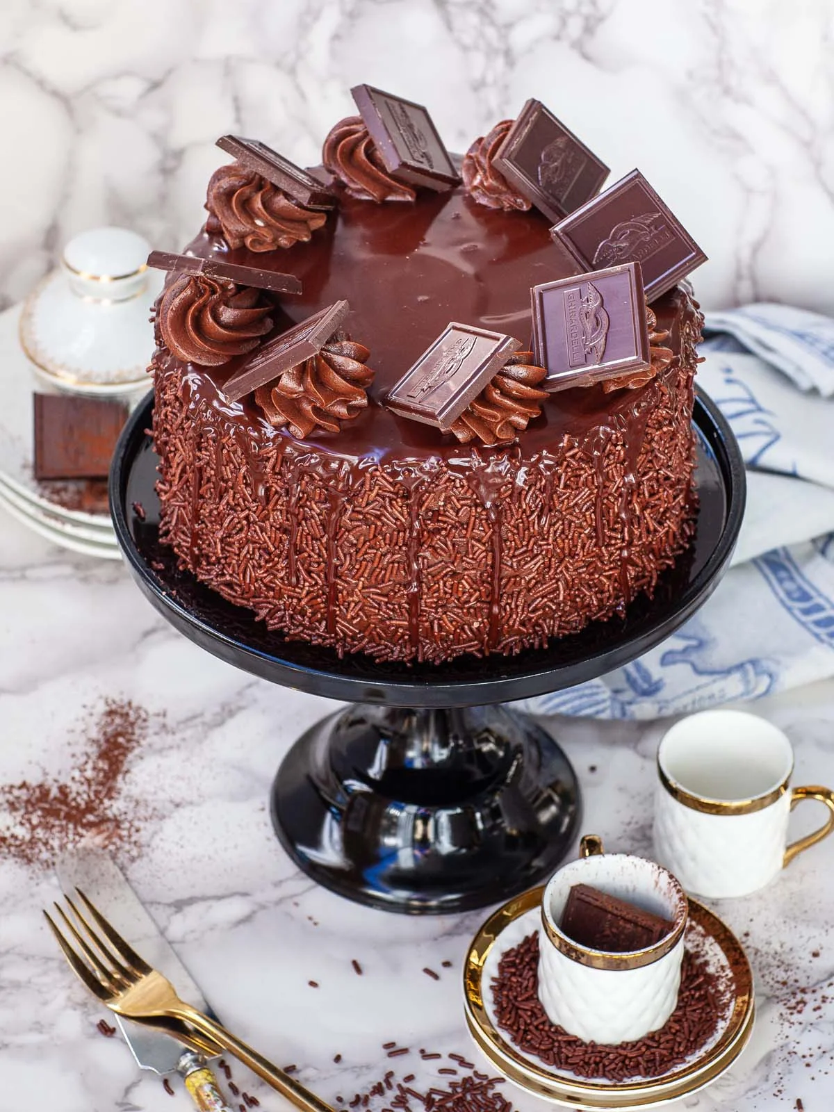 Bánh chocolate trang trí thanh chocolate và kem trên bàn tiệc