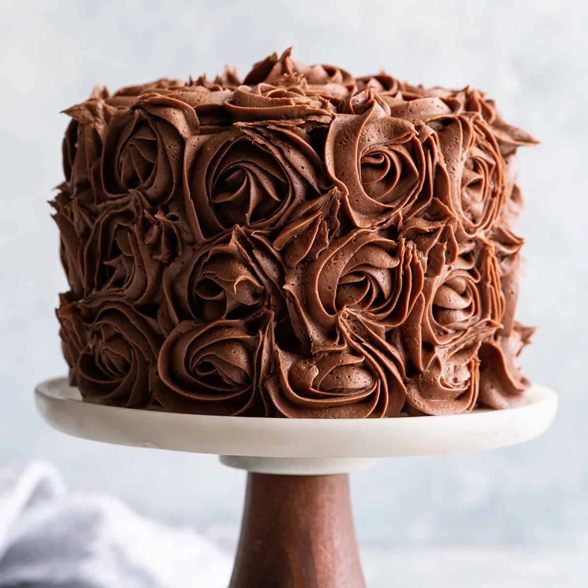 Bánh chocolate phủ hoa kem hình rosette trên đế bánh